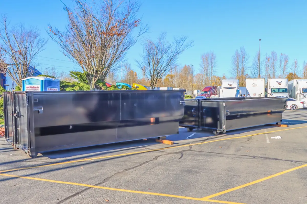 Professional dumpster rental service with roll-off container on residential driveway in Allouez